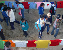 People looking at the Clothesline Project.