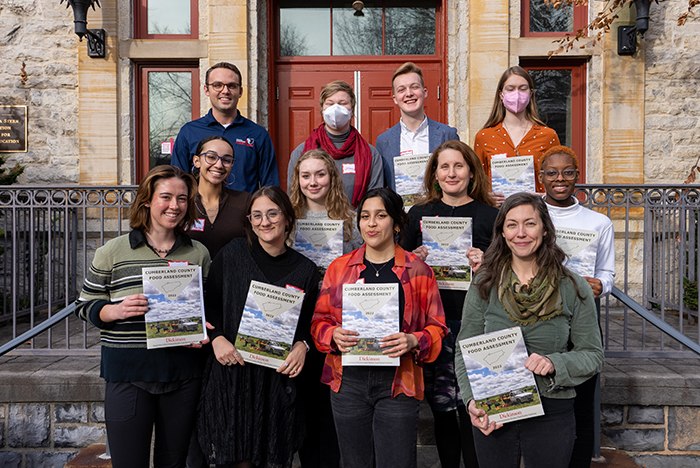 Student-researchers pose with their reports of original research on food access in Cumberland County, Pa. The students presented their work in early December. Photo by Dan Loh.