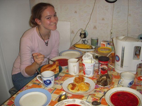 student eating traditional russian borshch