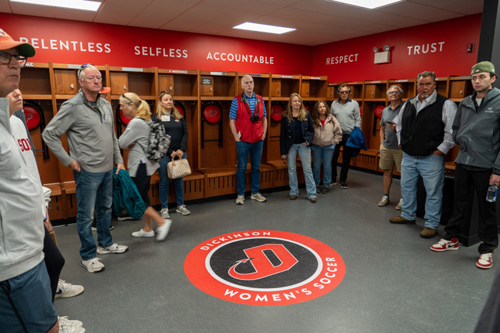 Attendees tour the facility's locker rooms following the event. Photo by Dan Loh.