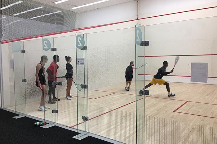 Squash players practice inside the Kline Center squash courts.