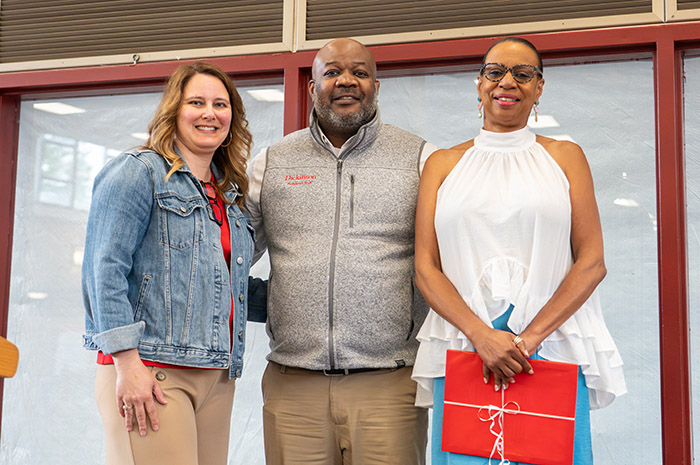 Presenters Maria Ritchie and Tony Boston present an inaugural Distinguished Staff Award to Yvette Davis (far right). Photo by Dan Loh.