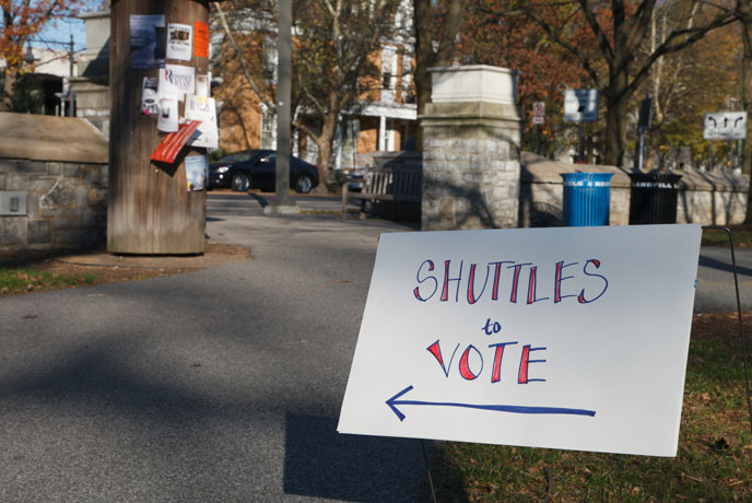 Students take shuttle buses to a local polling place throughout the day. Signs such as these point the way.