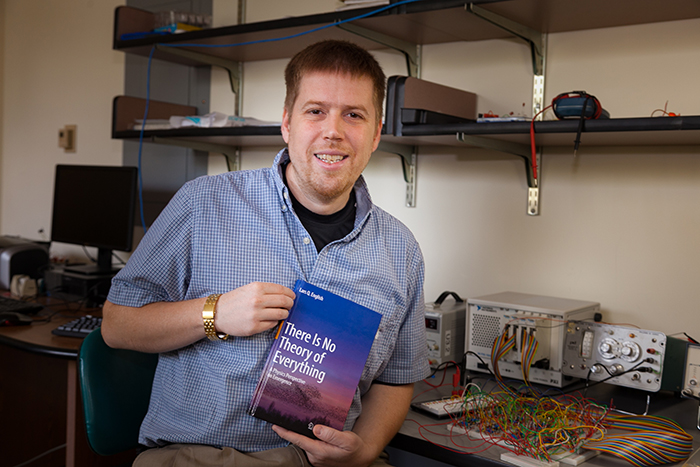 Lars English displays his new book, There is No Theory of Everything.