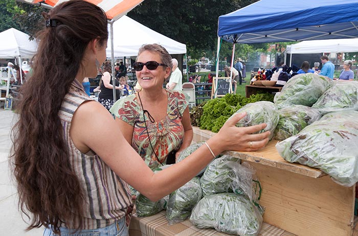 Shopping is a community experience at Farmers on the Square, a weekly, seasonal market located just blocks from campus, where foodies can snap up goodies from the College Farm and other local vendors. Photo by Carl Socolow '77.