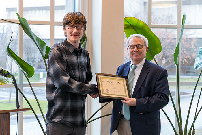 Provost and Dean Neil Weissman presents the FYS writing award to Evan Bates '23. Photo by Carl Socolow.