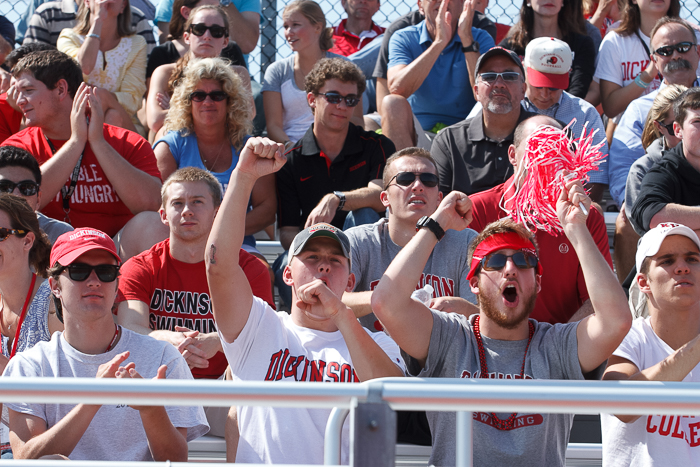 Crowd cheering at Homecoming football game.