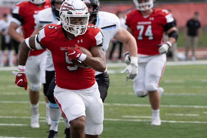 A football player runs with the ball