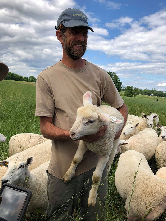 Matt holding a lamb.