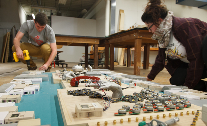 Students put the finishing touches on their sculpture.