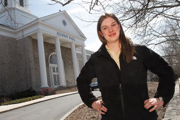 Allison Hall poses in front of Allison Hall