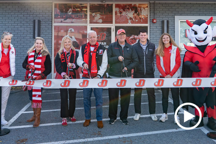 Members of the community gather for a ribbon cutting.
