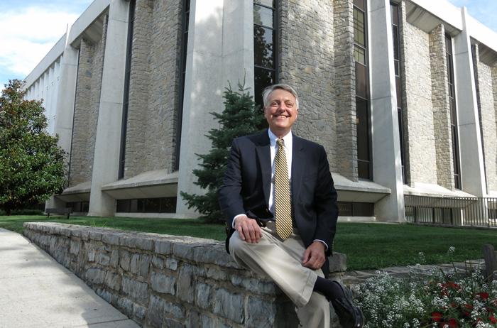 Robert Renaud sits outside Dickinson's library