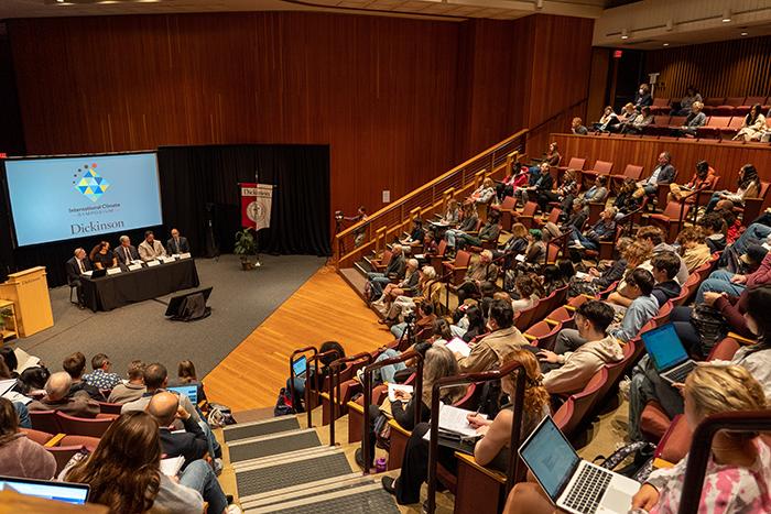 Audience members seated inside the Anita Tuvin Schlechter Auditorium during the International Climate Symposium.