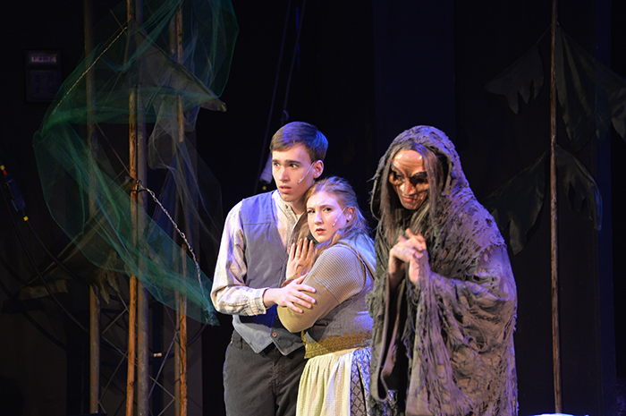 Three actors onstage. Two look frightened.