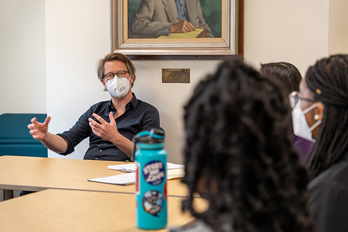 Jan Wagner works with students in a creative-writing class. Photo by Dan Loh.