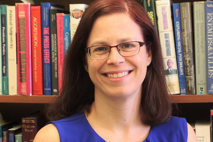 Portrait of Joanne Miller in front of a bookcase.