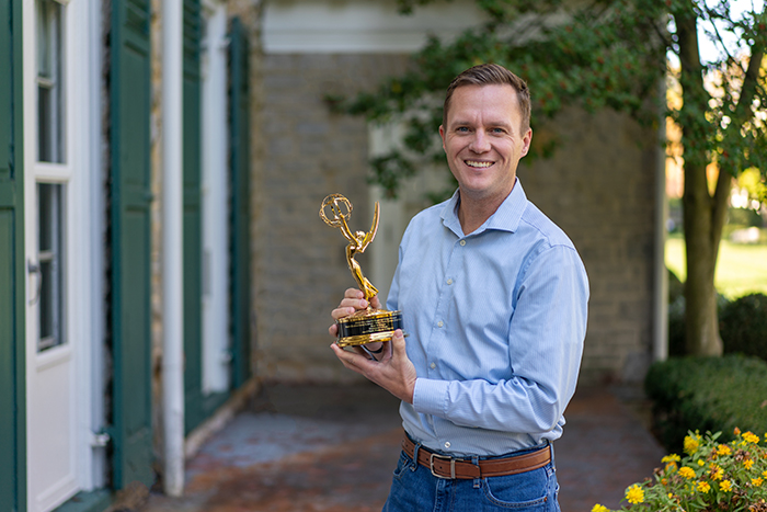 Joe O'Neill, senior director of visual media, displays his 2023 Emmy Award. Photo by Dan Loh.