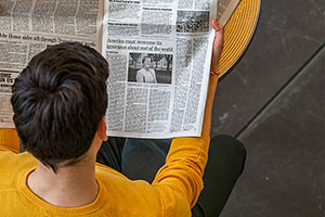 student reading newspaper