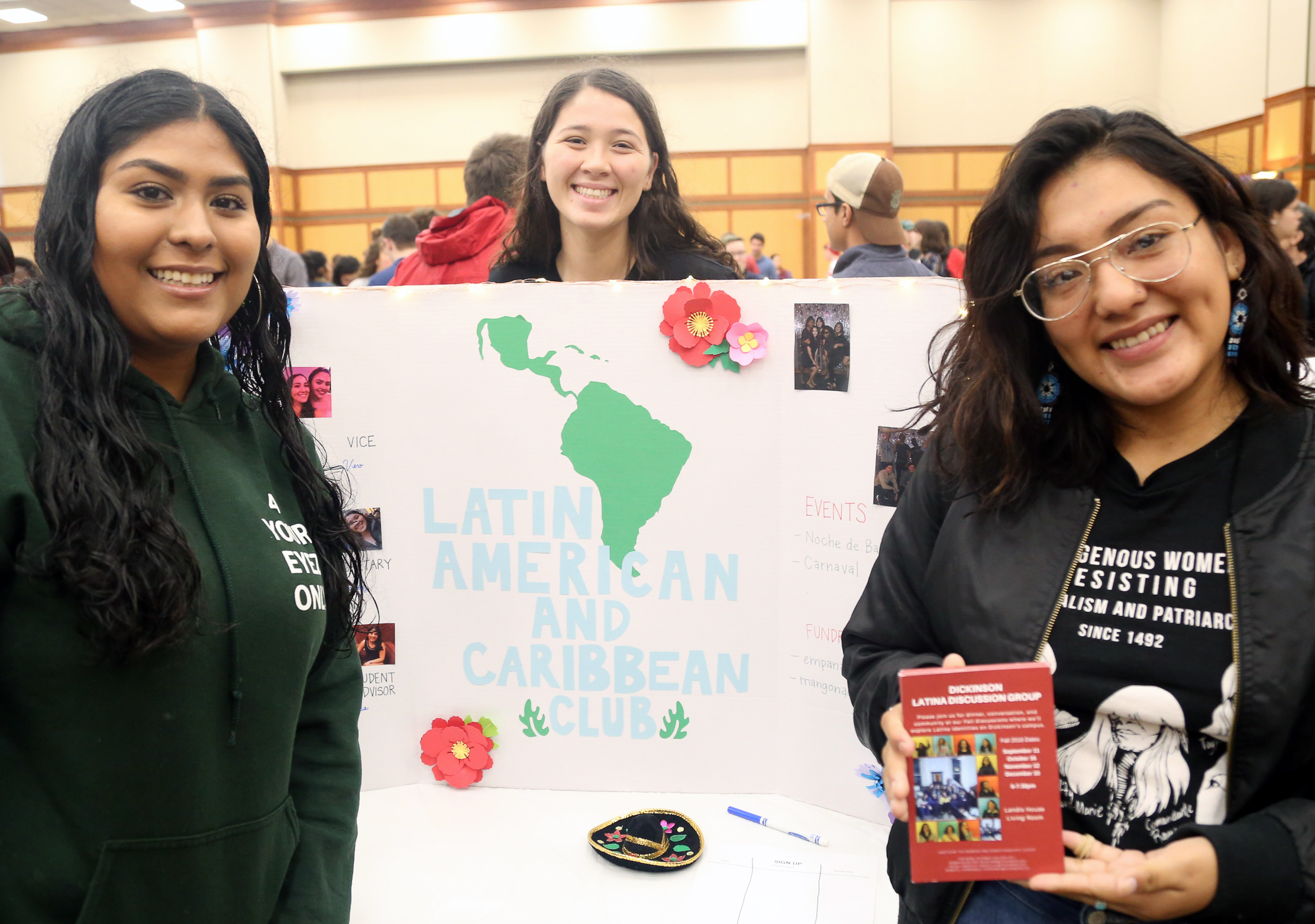 students showing their LALC club poster