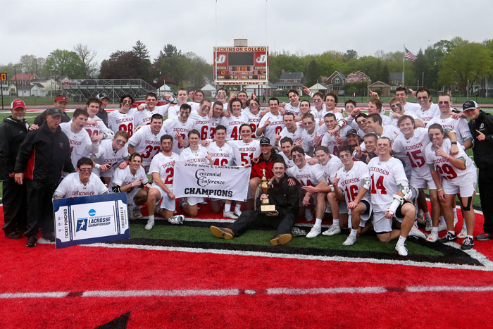 the lacrosse team poses after winning the championship