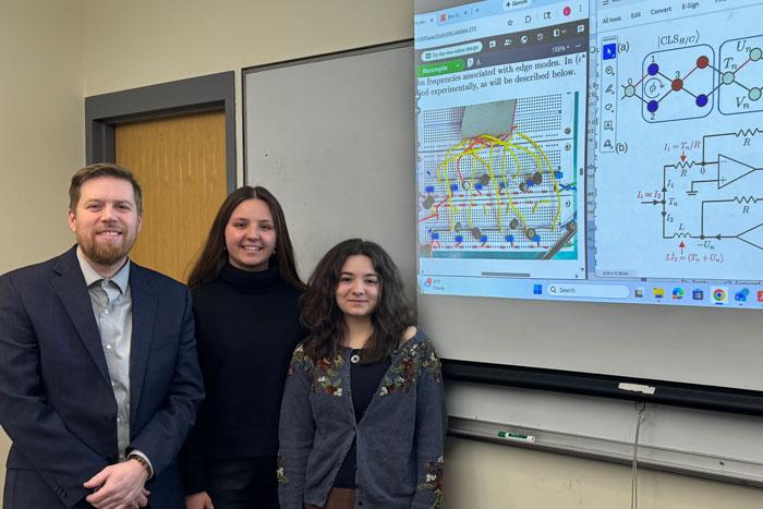 Prof Lars English and two students