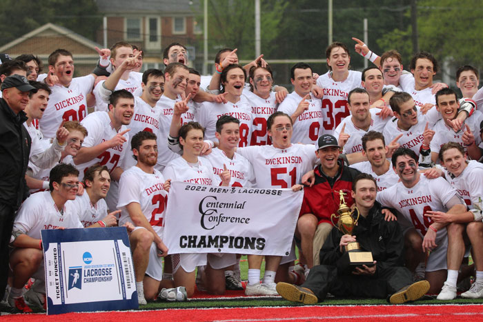 the lacrosse team poses after big win