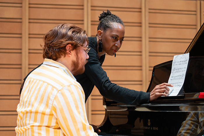 Maria Corley instructs a student-musician learning her work. Photo by Dan Loh.