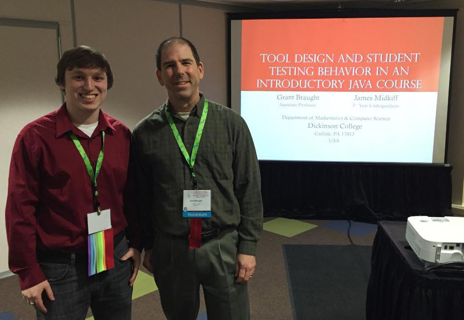 Student and professor at a presentation.