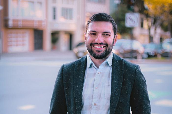 Portrait of Matthew Guariglia standing on an urban street.