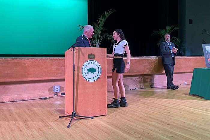 Maya Reichenbach and Dickinson Pres. John E. Jones stand at a podium.