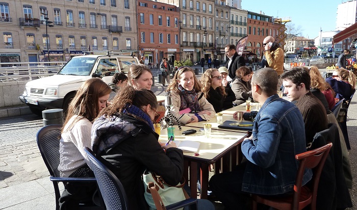 Students around a table together.