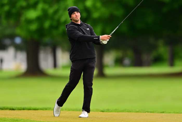 Collin McMahon swings a golf club