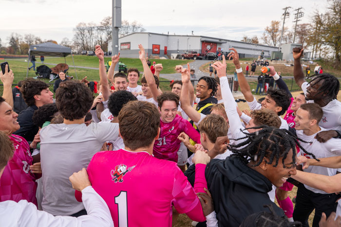 The team erupts in victory