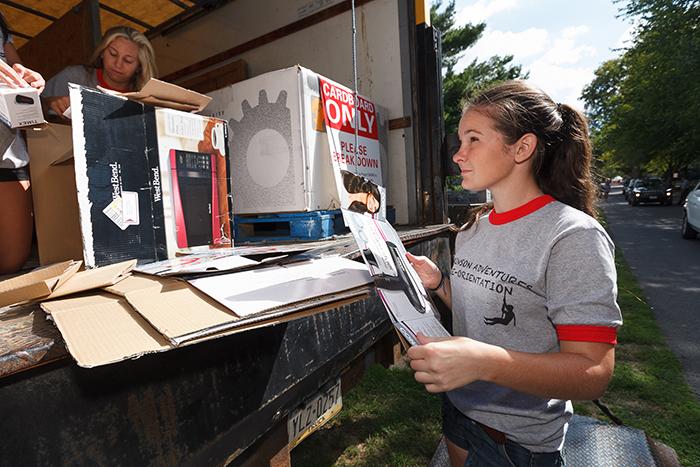 Photo of Dickinson student recycling cardboard