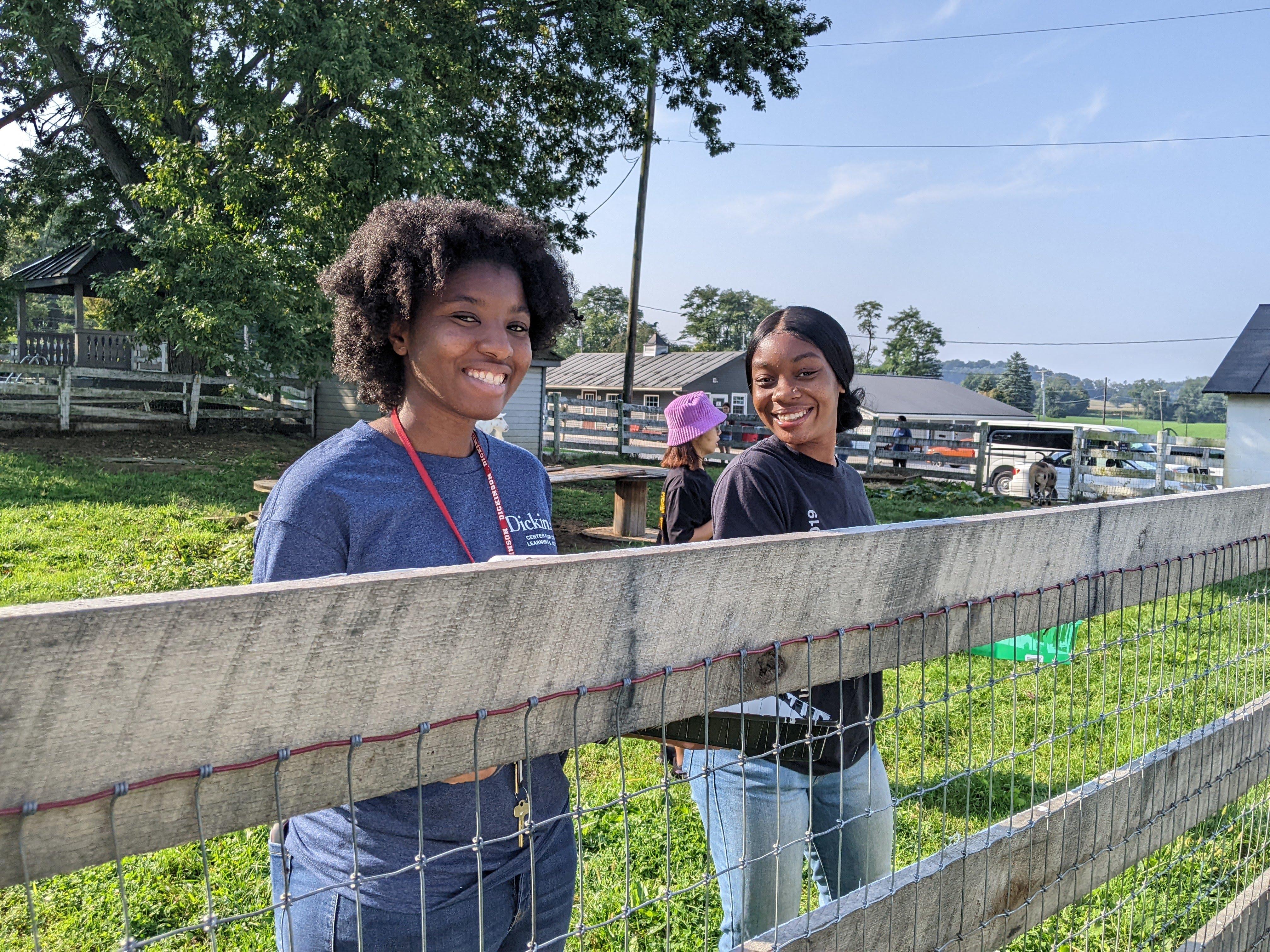 Photograph of Sariah Franklin and another student at the Red Tomato Farm 