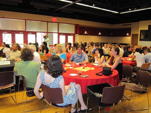 Students sit and enjoy the food and entertainment.