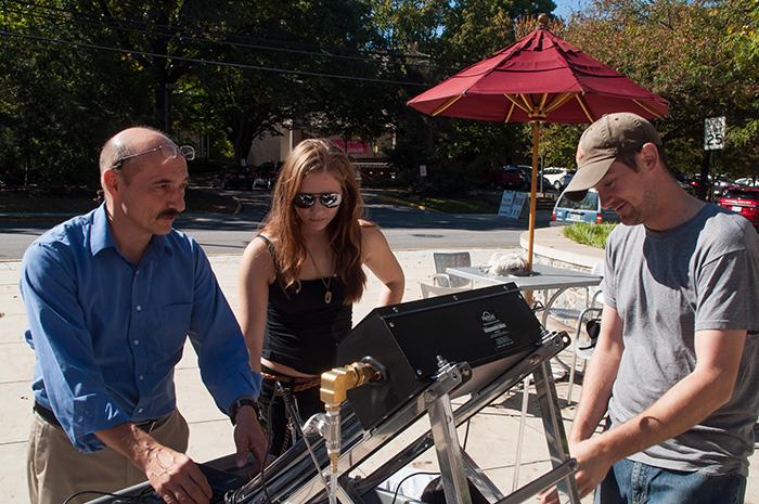 Hans Pfister teaches workshop participants how to make a solar hot water heater in the first of a series of three sustainability workshops available this fall.