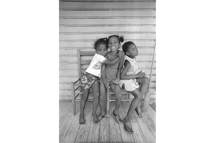 three girls pose in a chair