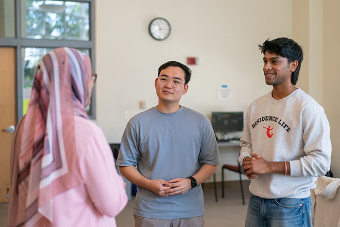 Dickinson juniors John Lee (center) and Hemanth Kapa (right) chat with Assistant Professor of Computer Science Farhan Siddiqui. Photo by Dan Loh.