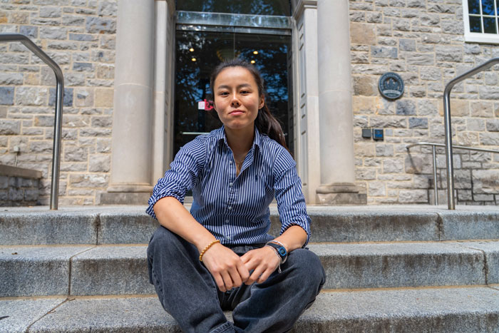 Lulu Wang sits on steps