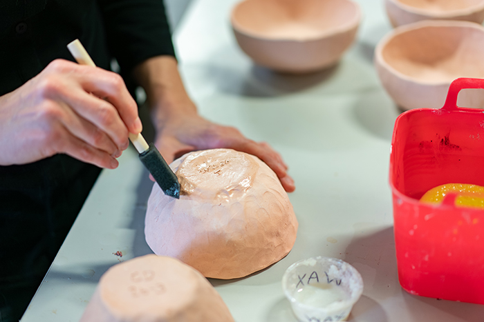 To help local artists make informed decisions about the ways their works may be used, Dickinson chemistry students are testing how ceramics glazes used at the Carlisle Arts Learning Center perform under test conditions. Photo by Dan Loh.