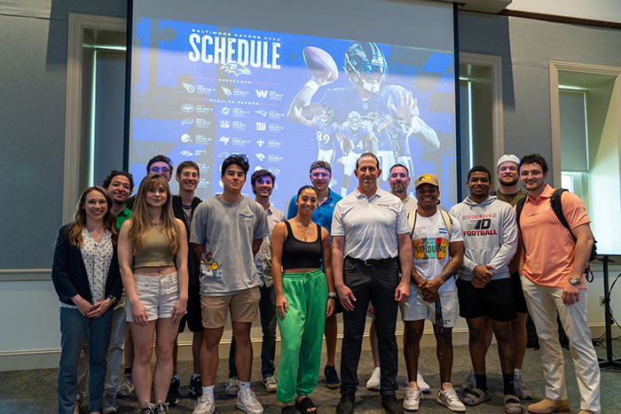 Students who attended the career-exploration event pose with Scott Cohen '91 (center) and Emily Marshall, associate professor of economics and data analytics (front, far left). Photo by Dan Loh.