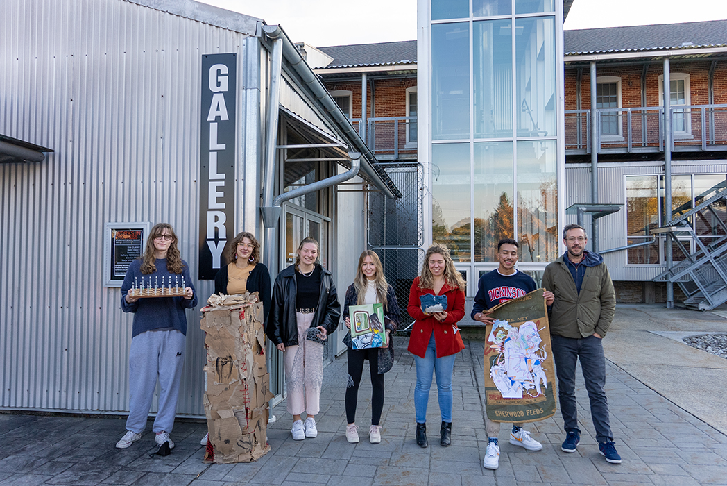 Studio-art majors in the class of '22 pose with Associate Professor of Art Todd Arsenault in front of the Goodyear Gallery, ahead of their midyear gallery show. Photo by Dan Loh. 