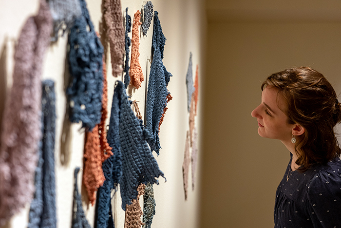 Xenia Markosky '24 (art & art history, Middle East studies) views ceramic works by Rebecca Fox '22 (art & art history). Photo by Dan Loh.