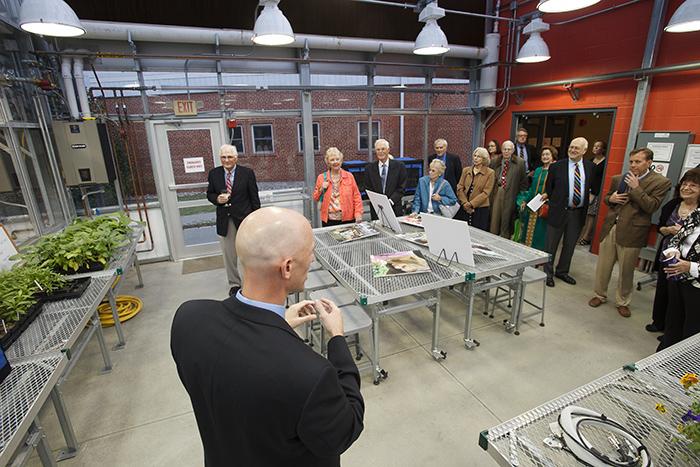 Tom Arnold, associate professor of biology, leads a tour of the Inge. P Stafford Greenhouse for Teaching and Research during the building's dedication.