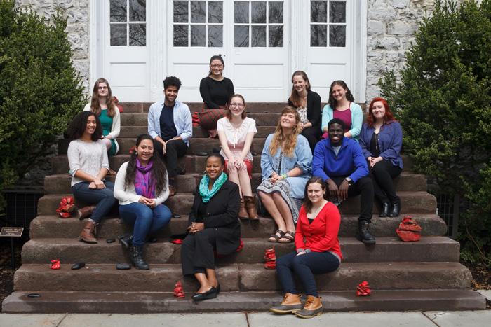 Students and Edwidge Dandicat pose on the steps of Old West