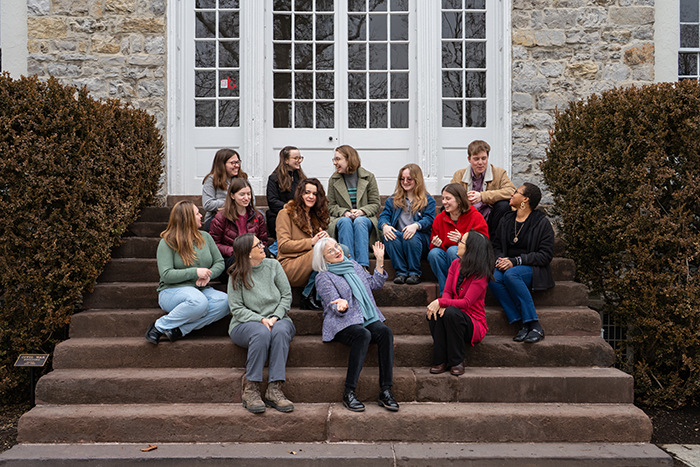 Molly Peacock (front, center) poses with creative writing students and faculty on the steps of Old West. Photo by Dan Loh.