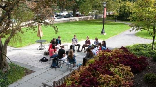 A Writing Associate meets with a group of writers for peer review.