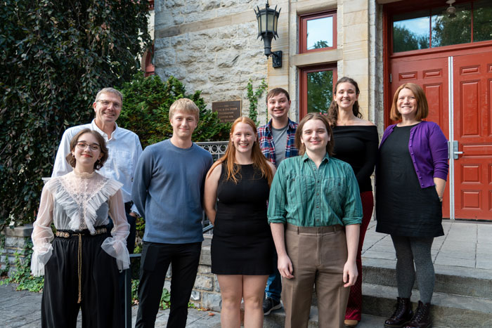 A group of attendees stands together outside
